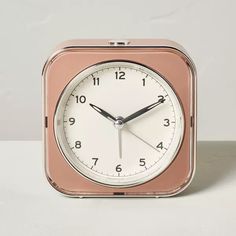 an alarm clock is shown on a white surface