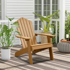 a wooden lawn chair sitting on top of a deck next to a potted plant