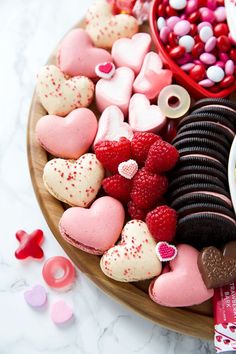 valentine's day cookies and candy arranged on a platter