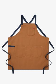 The All Day Crossback Apron draws inspiration from our favorite chefs. Our signature crossback straps enable carefree style and distribute weight across your shoulders and back for all day wearability. Big pockets and a towel loop add to our classic functionality. Our beautiful, lasting materials make this apron an instant icon constructed to last a lifetime. • Criss cross straps take pressure off your neck • Lotsa pockets and a utility loop for all your gear • 33" x 30" body, 72" straps 100% Co Man Apron, Crossback Apron, Brown Apron, Flat Kitchen, Sew Clothing, Shop Apron, Chef Uniform, Apron Pattern, Maine Lobster