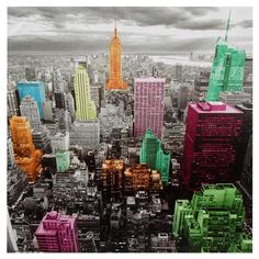 an aerial view of a city with tall buildings and colorful skyscrapers in the foreground