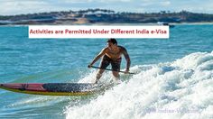 a man riding on top of a surfboard in the ocean next to a beach