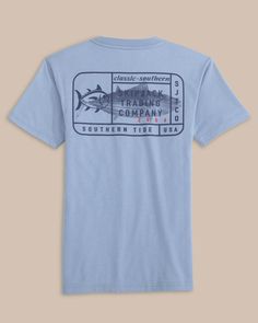 The back view of the Southern Tide Kids Skipjack Trading Co Short Sleeve T-Shirt by Southern Tide - Eternal Blue Washed Blue Graphic Tee With Screen Print, Graphic Tee With Screen Print In Washed Blue, Graphic Tee In Washed Blue With Screen Print, Washed Blue Graphic Tee With Graphic Print, Washed Blue Graphic Tee With Print, Washed Blue Graphic Print Crew Neck Top, Washed Blue Crew Neck Top With Graphic Print, Washed Blue Graphic Print T-shirt, Relaxed Fit, Vintage Washed Blue Crew Neck Top