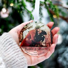 a person holding a christmas ornament in their hand