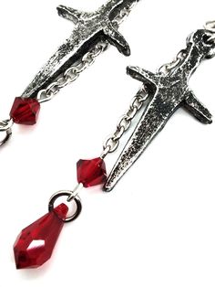 Made to Order! Perfect for when you're feeling stabby, these daring earrings are paired with blood-red drops to add drama to your style. These small daggers bring confidence and a subtly sinister aura to their wearer with their unique design, sculpted in our studio. They're cast in lead free pewter by hand and weathered. A lovely and affordable way to start your jewelry collection, expand your cabinet of treasures, or give a gift to a spooky friend. Pair them with our vampiric amulet or skull an Red Punk Earrings For Gifts, Vampire Style Metal Pierced Earrings, Red Gothic Earrings For Pierced Ears, Edgy Red Earrings As Gift, Edgy Red Earrings For Gift, Edgy Red Earrings For Gifts, Vampire Style Dangle Earrings, Edgy Red Jewelry Gift, Edgy Red Jewelry For Gift