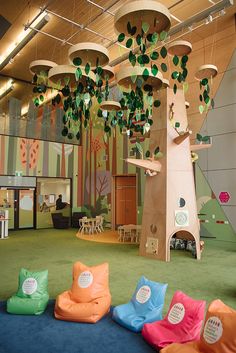 an indoor play area with trees and bean bags