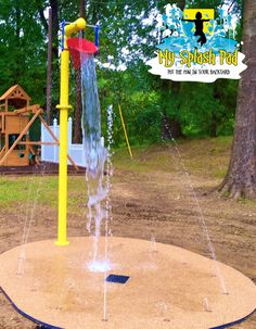 an outdoor play area with water spouting from the top