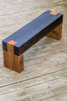 a wooden bench sitting on top of a wooden floor