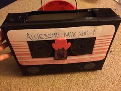 someone is holding up an old school cassette with the words awesome mix vol 1 on it