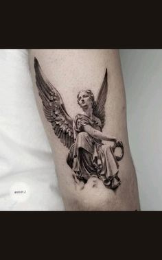 an angel tattoo on the arm of a man