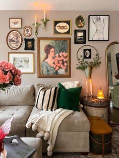 a living room filled with lots of furniture and pictures on the wall above it's couch