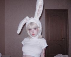 a woman in bunny ears is posing for the camera