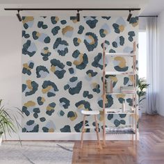 an abstract wallpaper with blue, gold and white spots on it in a living room