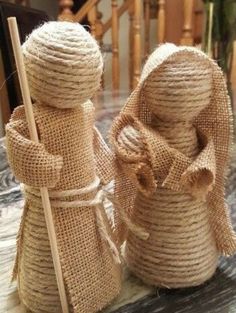 two burlap twine wrapped snowmen sitting on top of a marble table