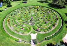 an aerial view of a circular garden in the grass