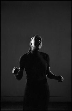 a black and white photo of a woman laughing