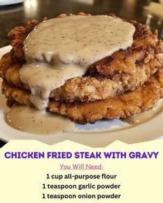 chicken fried steak with gravy on a white plate