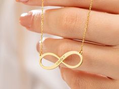 "Introducing our Custom Infinity Necklace--a timeless symbol of endless love and connection. Made with high-quality materials, it exudes both durability and elegance. The infinity symbol represents infinite possibilities, making it a perfect gift for loved ones or a cherished keepsake. The adjustable chain ensures a comfortable fit for all. Embrace the beauty of everlasting love and carry your personalized message close to your heart with this stunning and meaningful accessory.   The Perfect Gif Minimalist Engraved Infinity Jewelry, Personalized Infinity Jewelry, Personalized Infinity Jewelry For Her, Personalized Infinity Jewelry Gift For Her, Symbolic Infinity Jewelry For Anniversary, Symbolic Infinity Jewelry For Gifts, Infinity Symbolic Jewelry For Gift, Symbolic Infinity Jewelry For Gift, Symbolic Infinity Gold Jewelry