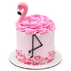 a pink flamingo cake with sprinkles on it and the number one