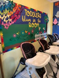 there are three baby seats in front of the wall with children's room written on it