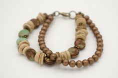 This 7-inch multi-strand beaded boho bracelet was handmade with care just for you. I used 8mm Imperial Jasper stones, and 6mm coconut wood donuts with brass embellishments on one strand, and 4mm bronze metal beads on the second strand. These two strands are made using Beadalon #19 (0.61mm) wire and are secured with a brass lobster clasp.  Bracelet shown measures 7 inches in length. Fits comfortably on a 6 inch wrist and is perfect for any occasion. Bohemian Brown Beaded Copper Bracelets, Rustic Brown Bracelets With Natural Stones, Bohemian Brown Copper Beaded Bracelets, Brown Copper Beaded Bracelets With Round Beads, Nature-inspired Brown Beaded Bracelets With Natural Stones, Rustic Wooden Beads Bracelet, Handmade Nature-inspired Brown Bracelet, Handmade Brown Nature-inspired Bracelet, Nature-inspired Handmade Brown Bracelet