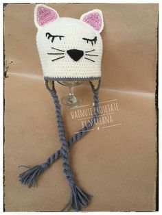 a crocheted hat with a cat's face on it