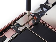 there is a small piece of tape attached to the back of an iphone's motherboard