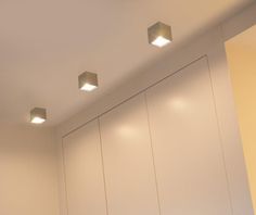 three recessed lights are mounted on the wall