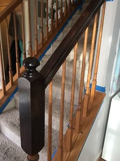 a wooden banister on the side of a stair case in a house under construction