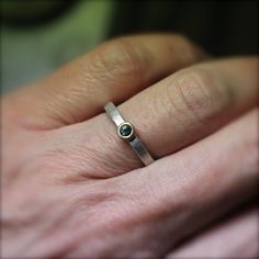 a woman's hand with a diamond ring on it