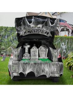 the trunk of a car is decorated with skulls and tombstones