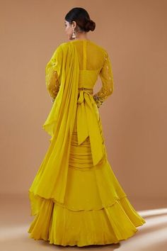 Mustard can can attached draped ruffle lehenga saree in layered silhouette, embellished by sequins. Comes with padded floral embroidered blouse and embellished belt. - Aza Fashions Wedding Draped Cutdana Dress, Cutdana Draped Wedding Dress, Traditional Drape Wedding Gown With Ruffles, Semi-stitched Anarkali Set With Ruffles For Wedding, Traditional Gown With Ruffles And Traditional Drape, Traditional Gown With Ruffles And Drape, Fitted Anarkali Draped Lehenga, Fitted Draped Anarkali Lehenga, Fitted Anarkali Style Draped Lehenga