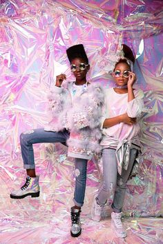 two young women posing for a photo in front of a pink background with tin foil