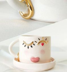 a white cup with gold rings on it