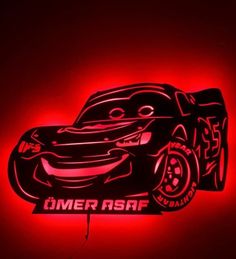 a red light that is on the side of a wall with a car painted on it