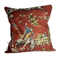 a decorative pillow with an image of cowboys on horseback