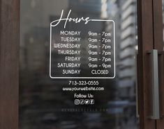 a sign is posted on the glass door of a building that has closed for hours