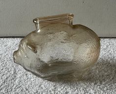 a glass vase sitting on top of a white carpet