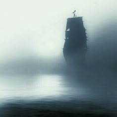 an old ship in the middle of foggy water