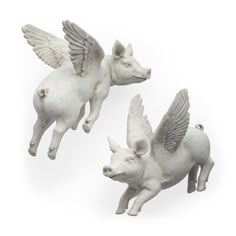 three figurines of pigs flying in the air with wings on their backs,