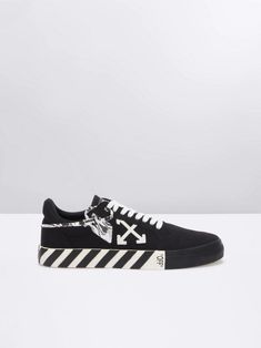 Shop Black/white cotton Vulcanized low-top sneakers from OFF-WHITE featuring logo patch to the side, logo patch at the tongue, round toe, front lace-up fastening, striped flat sole and marbled security tag to the side. Due to the dyeing process used, this product must not come into contact with water.. Streetwear Skate Shoes With Logo-print Tongue, Canvas High-top Sneakers With Logo Print For Streetwear, Streetwear Lace-up Skate Shoes With Logo, Low-top Skate Shoes With Logo-print Tongue For Streetwear, Lace-up Skate Shoes With Logo For Streetwear, Urban High-top Sneakers With Logo-print Tongue, Casual Lace-up Skate Shoes With Logo-print Tongue, Black Canvas Sneakers With Logo Print, Logo Print Lace-up Skate Shoes For Streetwear