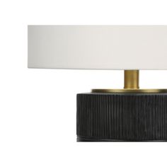 a black and gold lamp with a white shade on the top, against a white background