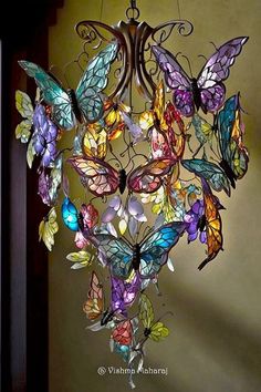 a chandelier with many colorful butterflies hanging from it