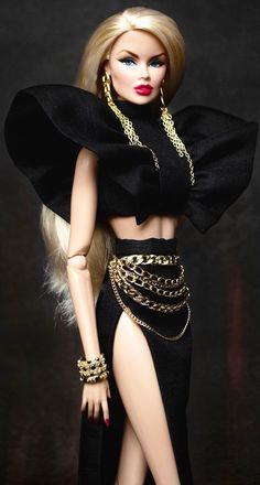 a barbie doll wearing a black outfit with gold chains around her waist and legs,