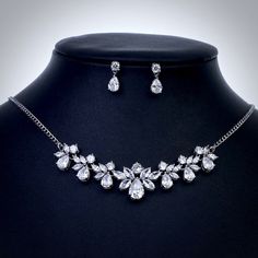 A beautiful two-piece bridal jewelry set with an incredible sparkle! Adorned with intricately faceted cubic zirconia that capture the light from every angle with a perfectly translucent appeal, the pieces are platinum plated for a flawless finish which enhances the intricate detailing and conveys a modern take on old elegance. Necklace: 18" (approx. 46cm) long with a lobster clasp and a 2" extension (if a longer length is needed, please leave a note with your desired length at checkout). Earring Goddess Wedding, Wedding Necklace Set, Wedding Jewelry Set, Bridal Necklace Set, Silver Wedding Jewelry, Bridal Jewelry Set, Leaf Jewelry, Silver Anklets, Bridal Bracelet