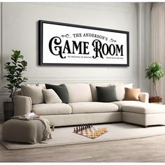 a living room with a couch, coffee table and chess board in front of a large framed game room sign