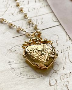 The Jardin Luxe Locket, my love locket is a beautiful locket you can keep your treasures close to the heart. Gold plated silver functioning heart locket and possible to adhere photo 5/8"x5/8" inches. Gold plated silver pearl rosary chain chain 20 inches in length. All items come in a gift box ready to gift. To see more please visit my Etsy shop at https://www.etsy.com/shop/BijouLimon How to add photo- use the closed locket as a template for the photo you want to use. You will need to cut the pho Love Locket, Locket Gold, Locket Jewelry, Pearl Rosary, Christmas Wedding Gifts, Latest Jewellery Trends, Chain Making, Heart Locket Necklace, Jewelry Lockets