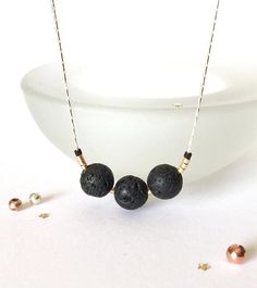 This beautiful minimalist necklace is made with amazing lava stone. Wear as is, or add a couple drops of your favourite essential oils to this natural lava rock diffuser, and experience wonderful aromatherapy! This simple everyday necklace is also a great for layering or lovely worn on its own.  🌿 This necklace has three 8mm size lava beads accented with premium gold and matte black seed beads. 🌿 Strung on a beautiful dainty sterling silver beading chain. Choose your length at checkout. 🌿 Your lovely necklace will come beautifully wrapped in tissue, a pretty organza/ cloth bag and ribbon ready for gift giving! PLEASE - READ - MY - POLICIES & FAQ https://www.etsy.com/shop/aprilhyltondesigns/policy Q U E S T I O N S  If you have any questions, please feel free to contact me here on Etsy. Lava Stone Necklace With Natural Stones For Gift, Everyday Lava Stone Jewelry With Natural Stones, Essential Oil Necklace, Lava Stone Necklace, Simple Necklace Everyday, Essential Oil Necklaces, Essential Oil Necklace Diffuser, Diffuser Jewelry, Christmas Style