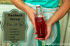 a person in an apron holding a bottle of rhubar syrup with the words rhubar syrup on it