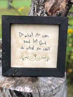 a framed sign on a tree stump that says do what you can and let god do what you can't